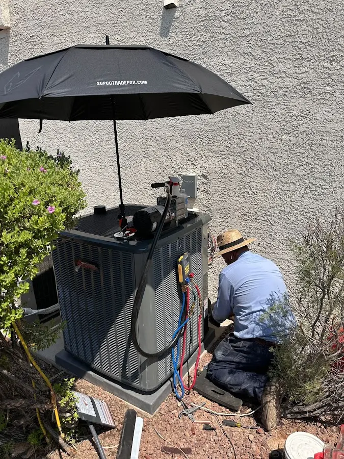 HVAC technician performing outdoor AC maintenance in Sunbury